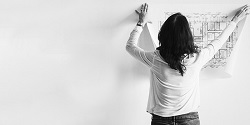 Black and white image of a woman with a written plan