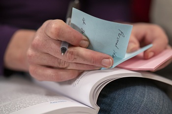 Image of a person looking through notes 