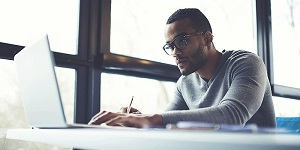 Image of male student using a laptop