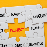 jigsaw puzzle with pieces showing the areas pf project management