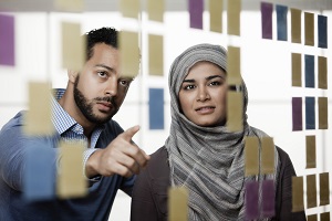 Picture of man and lady looking at organisation diagram