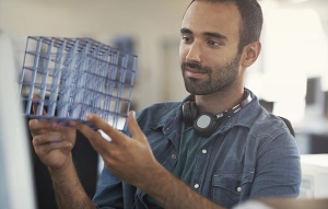 Picture of man looking at model