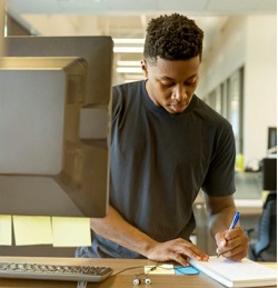 Image of man making notes at a desk