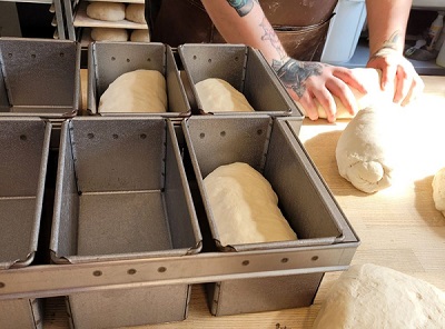 A person kneading bread