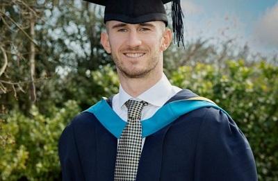 Dominic Ball in Graduation cap and gown