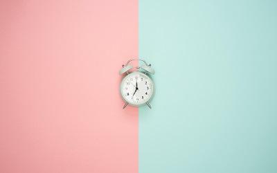 Photo by Icons8 Team on Unsplash - a clock on a pink and blue background