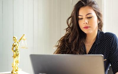 Photo by Mateus Campos Felipe on Unsplash - female lawyer on a laptop