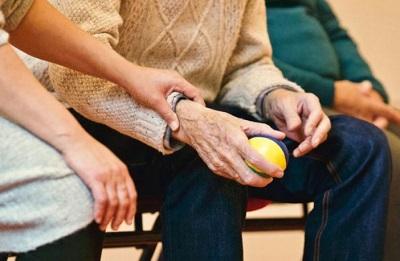 Elderly man holding juggling ball