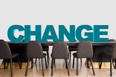 Image containing the word 'Change' on a boardroom table 