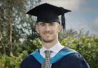 Dominic Ball in Graduation cap and gown